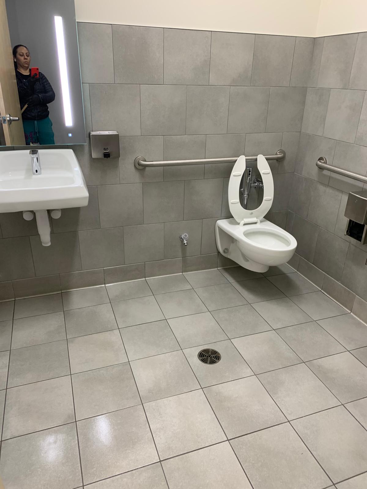 Professional clinical cleaning team disinfecting a medical exam room