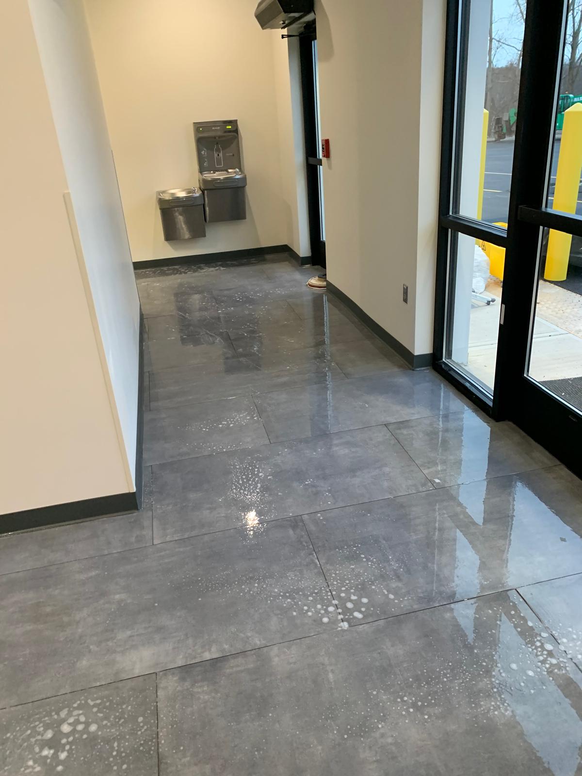 Day porter cleaning lobby area before and after