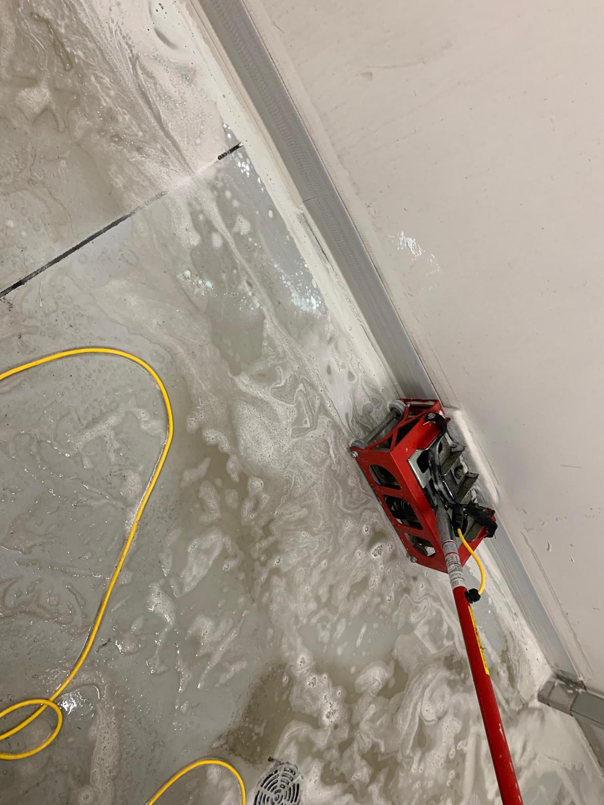 Technician applying floor buffing and refinishing in a commercial facility