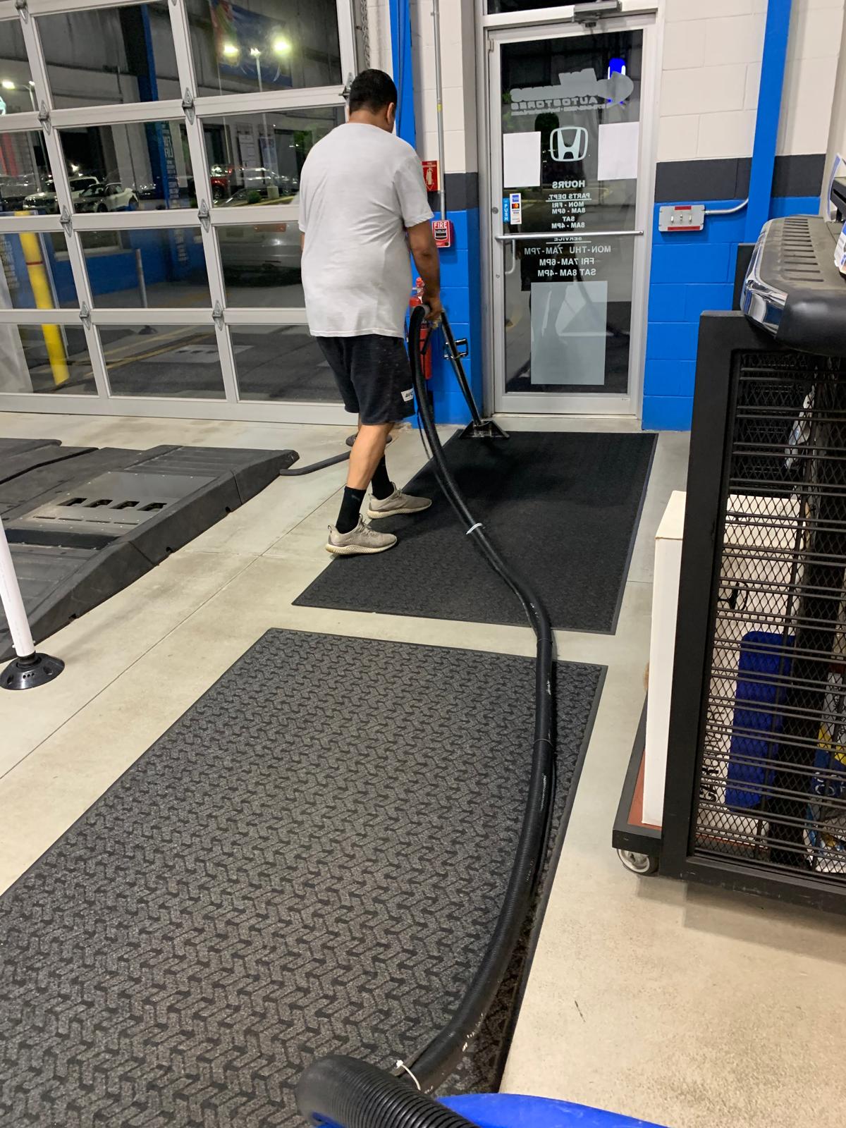 Supervisor reviewing nightly janitorial checklist inside a commercial building
